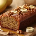 Freshly baked banana bread with bananas and nuts.